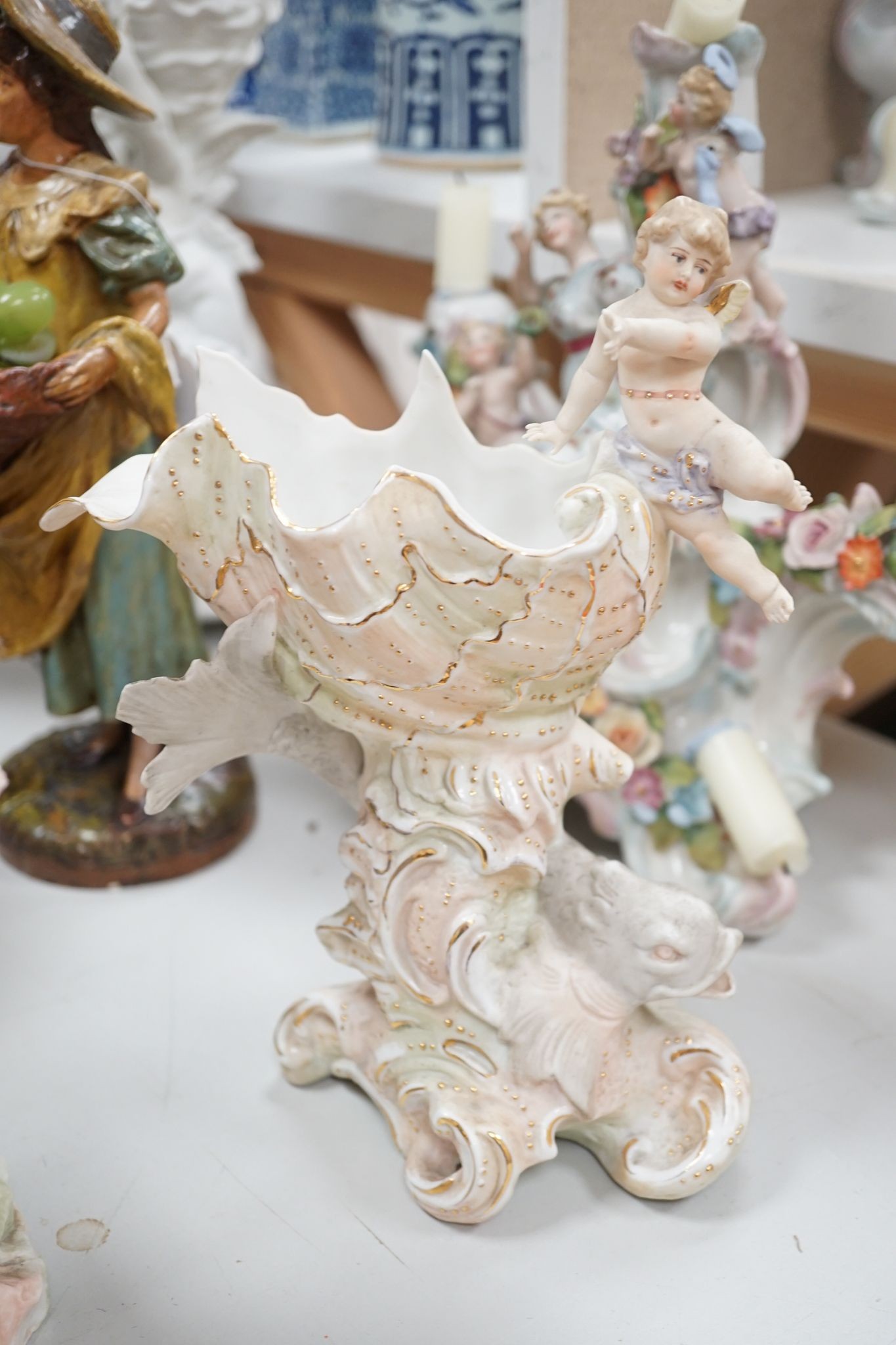 A group of Continental porcelain and pottery figural vases and centrepieces and two candelabra